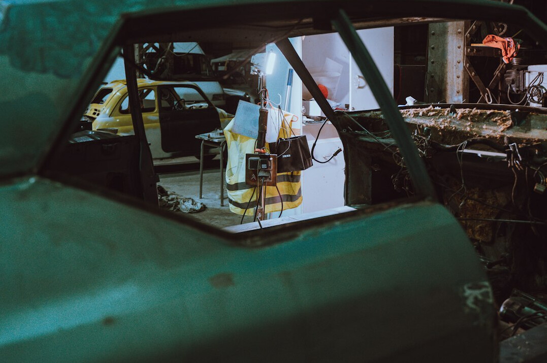 Car engine bay and bodywork in a repair garage